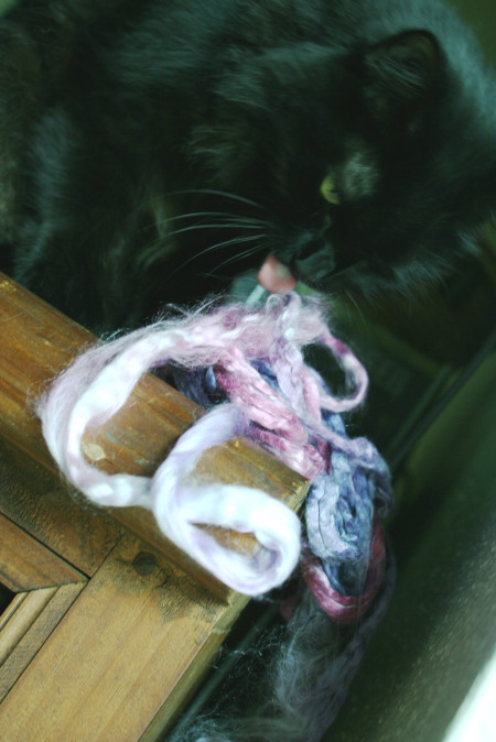 Feline Overlord licks the silk handpainted roving