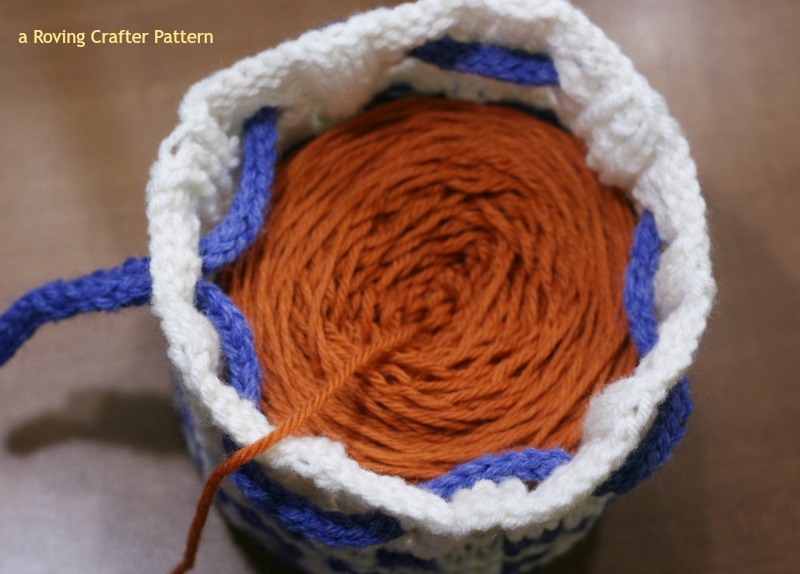 A yarn cake in its cake cozie