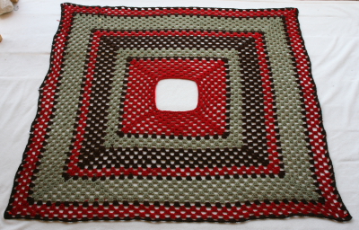 crochet granny square poncho as it blocks